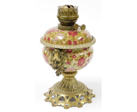A Fisher &amp; Budapest oil lamp, on ceramic body with floral decoration and pierced and flowered stem and foot, 35cm high. 