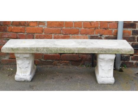 A reconstituted stone garden bench, the rectangular top on two plinths, 41cm high, 140cm wide, 37cm deep.