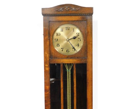 An oak cased longcase clock, with brass clock face, with floral banded arched top and mirrored central section, 186cm high, 4