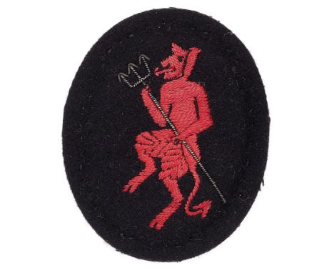 Inns of Court Regiment Officer’s beret badge WW2 period.Large padded black cloth oval bearing red silk Devil holding a triden