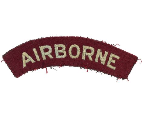 WW2 AIRBORNE cloth embroidered shoulder title.Light blue sans-serif letters embroidered on slightly curved maroon felt.    Re