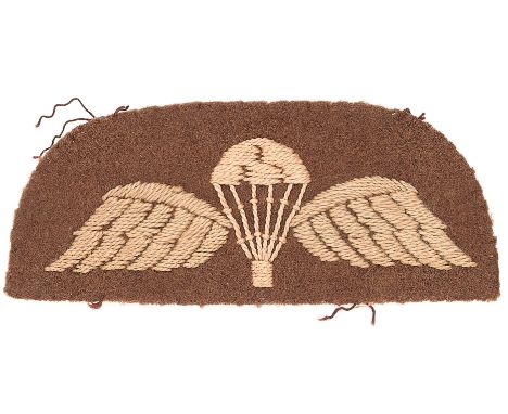 Early WW2 cloth Parachute qualification wings.Fine scarce example of white canopy flanked by faded light blue wings with cent