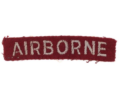 WW2 AIRBORNE cloth embroidered arm title/strip.Light blue sans-serif letters embroidered on maroon felt rectagle.   Removed f
