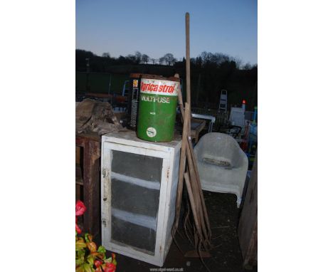 A quantity of garden tools, hay forks, a meat safe and two oil drums.