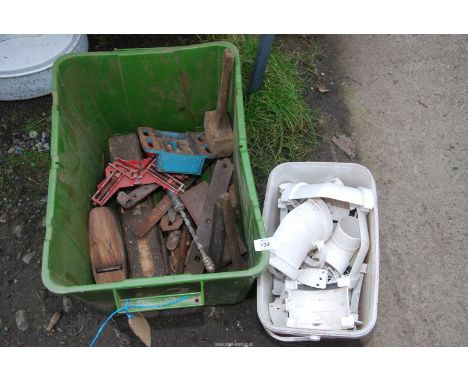 A box of wood-working tools and a tub of white plastic pipe fittings.