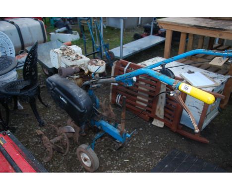 A petrol driven "Lion" Rotary tiller. (Has good compression).