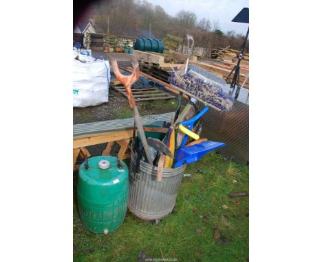 A galvanised bin, some garden tools, a snow shovel, etc. along with a green plastic fermenter for "H.P. Bulmers".