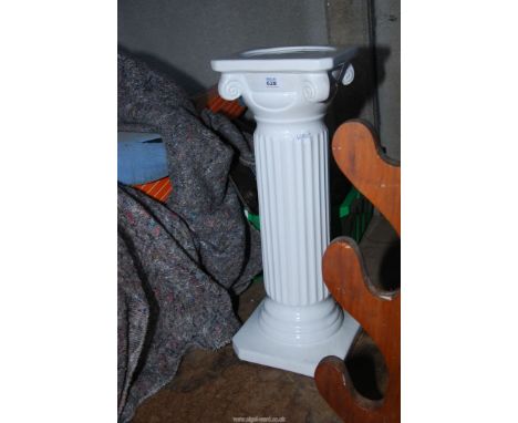 A white ceramic jardiniere stand/column.