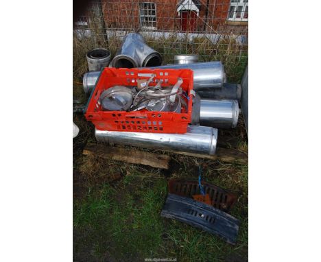 An enamel fire front and fire grate plus a quantity of stainless steel insulated flue pipe.