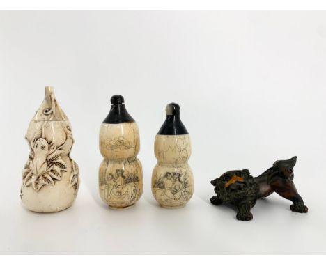 A carved Japanese bone scent bottle, a pair of erotically themed scrimshaw style similar along with a carved boxwood Foo dog 