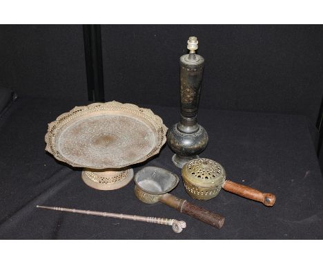 Lamp base decorated with flowers on a black ground, long stem pipe, large brass tazza on loose tall base etc. (5) lamp 46cm t