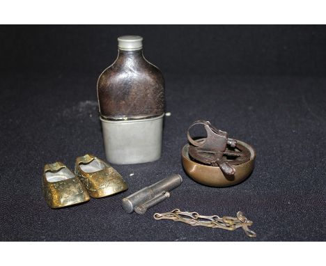 Works of art, to include a pewter and leather hip flask, a bell, a pair of miniature brass shies and a lighter, (5)