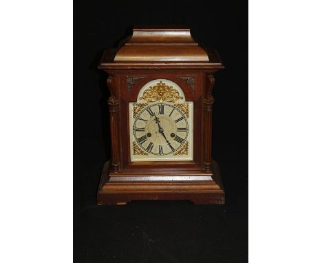 Edwardian mantel clock, the silvered dial with Roman numerals and gilt scroll and mask spandrels, the bevelled arched door fl