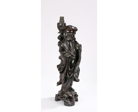 Republic of China era hardwood lamp carved as a figure of a boy holding a ruyi sceptre and fruits issuing from the other hand