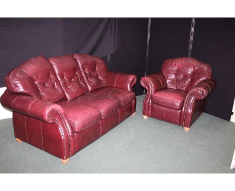 Brown leather three seater settee and matching armchair, with button back cushions, raised on light oak turned legs (2)