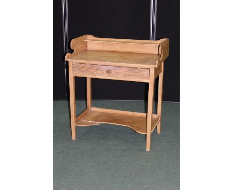 Victorian pine washstand, the three quarter splash back with shelf above a frieze drawer, on square legs united by a shaped u