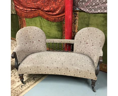 A Victorian two seat parlour settee. Supported on 4 mahogany turned legs and original brass castor feet. 