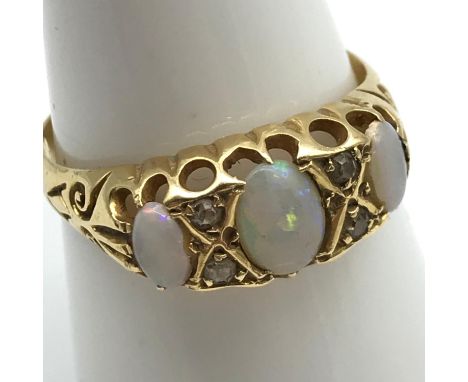 An 18ct gold ladies ring set with 3 large opal stones and 4 small diamonds. Ring size O, Weight 2.87grams 