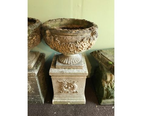 A Garden pedestal planter urn. Two Pieces. Detailed with leaf and flower design 