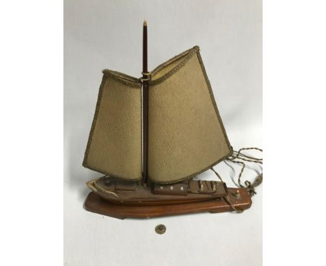 An Art Deco boat table lamp. Has original bakelite plug. Measures 40cm in height 