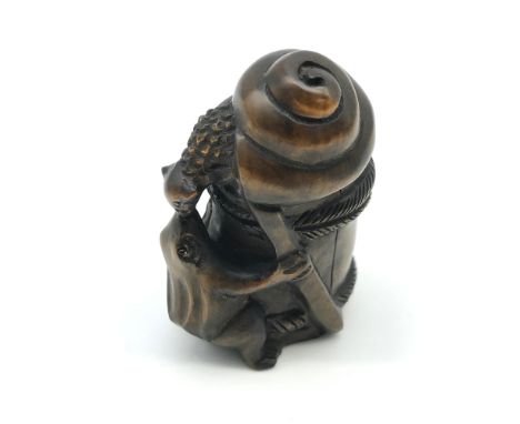 A Small antique Japanese hand carved frog and snail netsuke. Signed by the artist to the base. Measures 5cm in height 