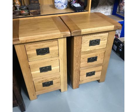 A Pair of Solid light oak contemporary three drawer bedside cabinets. Measure 70x45x40cm 
