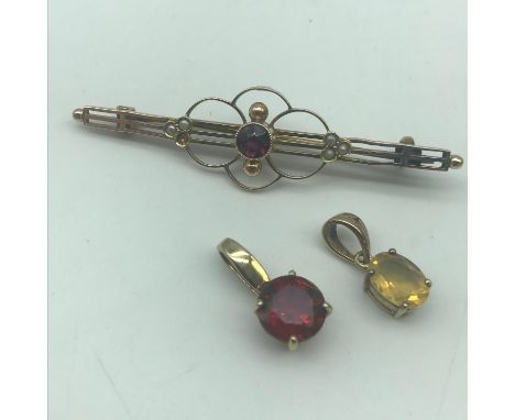 Art Nouveau 9ct gold ladies brooch set with seed pearls and pink ruby style stone. Together with two yellow metal pendants an