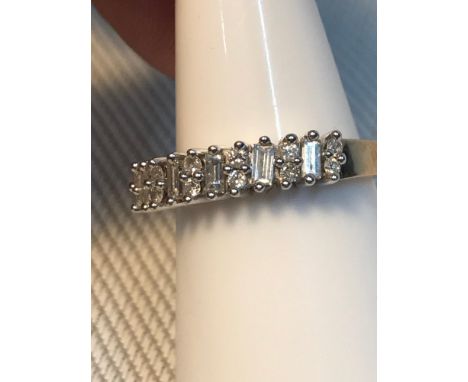 A Beautiful example of a ladies 9ct gold and 0.50ct diamond ring. Diamonds consist of 5 Baguette cut diamonds and 12 Round cu