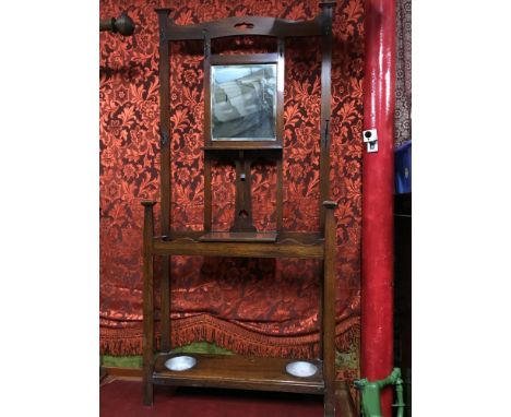 A Large Victorian hall way coat/Umbrella stand. Fitted with a single mirror, lift up storage area and double umbrella, walkin