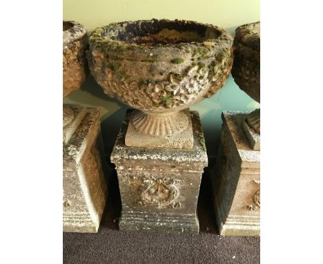 A Garden pedestal planter urn. Two Pieces. Detailed with leaf and flower design 