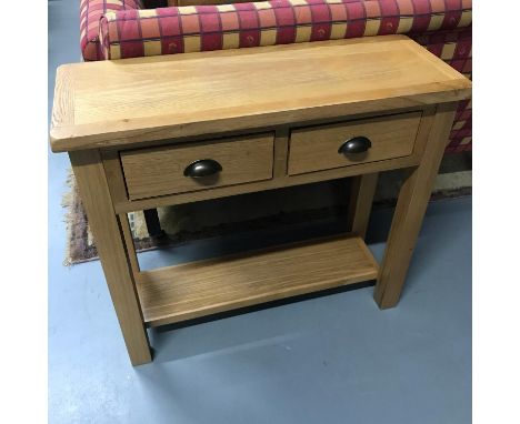 A Solid light oak contemporary two drawer console table. Measures 75x85x32cm 