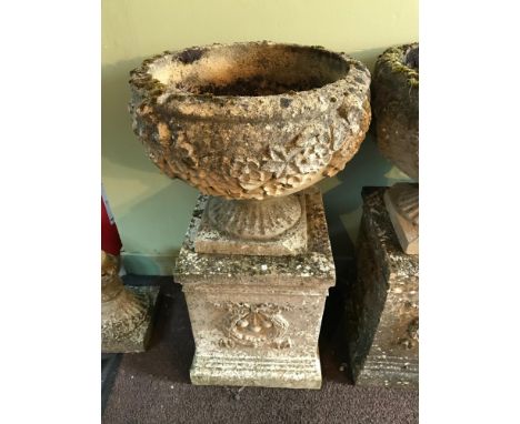 A Garden pedestal planter urn. Two Pieces. Detailed with leaf and flower design 