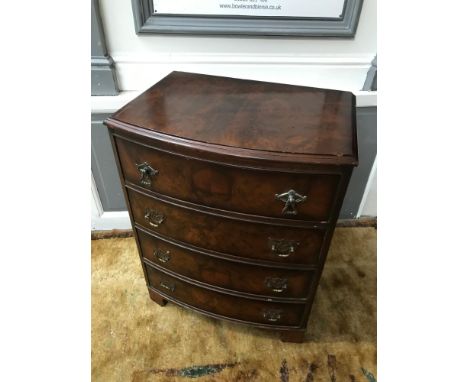 A Reproduction 4 drawer bow front chest. Measures 70x55x39cm 