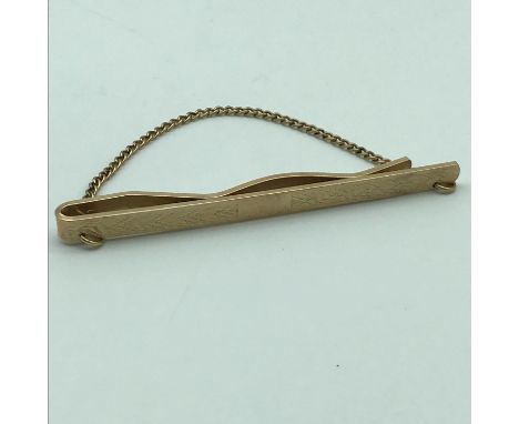 A 9ct gold front and back tie clip. Weighs 7.83grams 