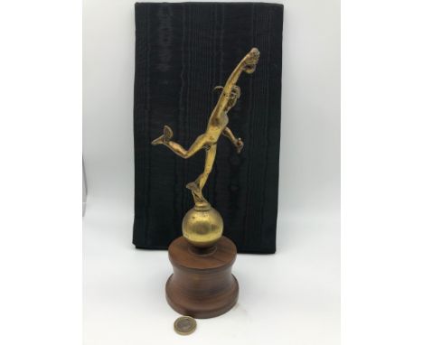 An art deco style Mercury running man metal figure sat upon a hardwood stand, Possibly car mascot or top of a clock. Measures