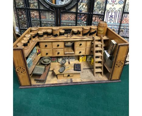 An early 1900's Antique Grocer's Shop originally made in Germany. Comes with a collection of barrel canisters, Advertising bo