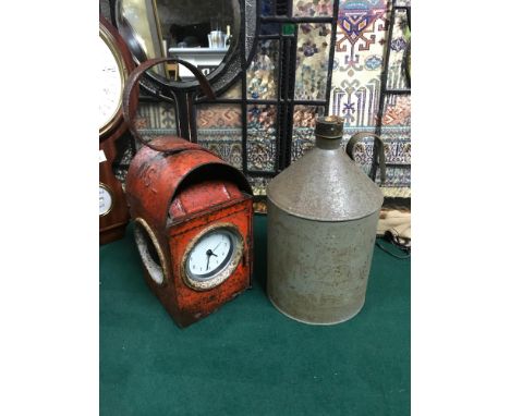 A Vintage railway lamp fitted with a modern clock working together with a vintage oil can 