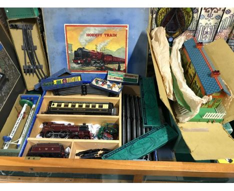 A Vintage Meccano Hornby Series O Gauge tin plate train set and accessories which includes Railway Accessories Luggage and tr