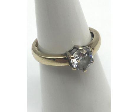 A Ladies 9ct gold ring set with a large clear stone. Ring size K. Also has engraved to the inside "I LOVE YOU" Weighs 2.20gra