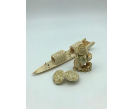 A Japanese meiji period Ivory carved netsuke of a man riding an ox. Signed t the base. Together with a carved fishing boat an