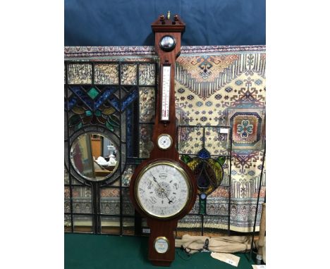 A Large banjo barometer produced in West German. Measures 112cm in length 