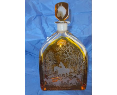 An Orrefors clear and amber glass overlaid decanter decorated with hunting scenes, the stopper decorated with a horse head an