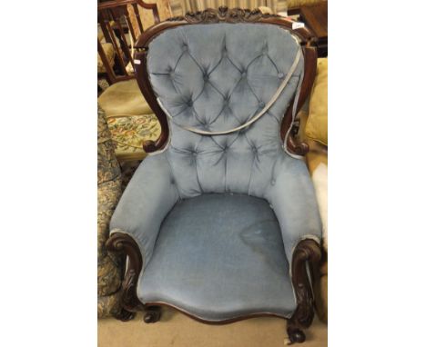 A Victorian button back upholstered tub chair, raised on turned and ringed legs, upholstered in a blue and salmon foliate dec