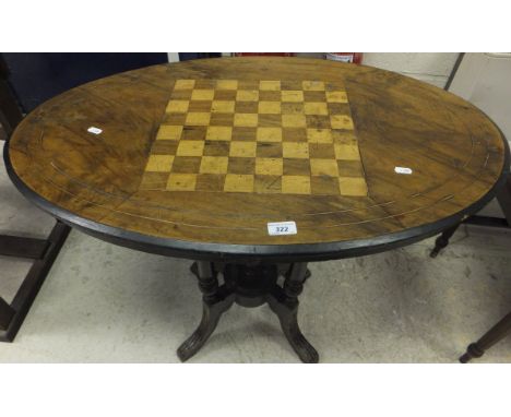 A collection of furniture comprising a mahogany chess board topped oval occasional table on four turned column supports unite