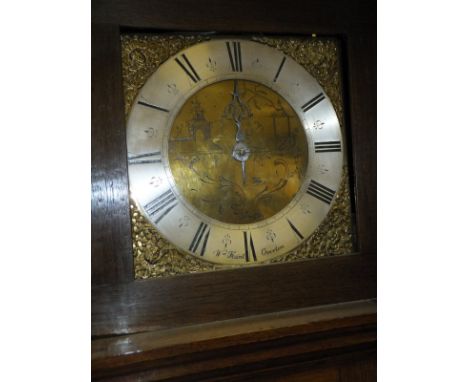 An oak longcase clock, the 30 hour movement striking on a bell, the silvered chapter ring with Roman numerals enclosing a chi