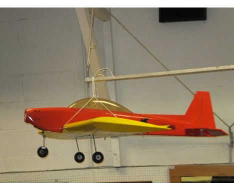 A large red and yellow model monoplane with winged scull and crossbones motif (no engine)
