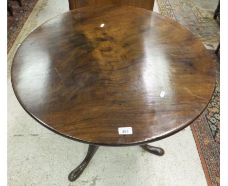 An early 19th Century mahogany tea table, the circular snap top on a turned pedestal to cabriole tripod base (cut down)