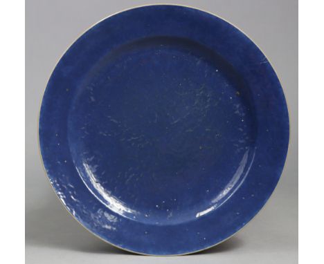 An 18th century Chinese porcelain powder-blue charger, with wide rim&amp; café-au-lait edge; 16” diam. (star crack to rim wit