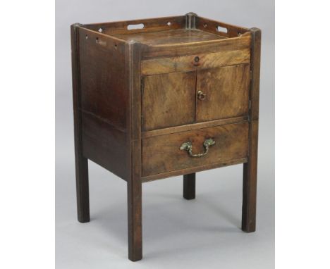 A Georgian mahogany bedside cupboard, adapted from a commode, with pierced tray-top gallery above a shallow drawer with cupbo