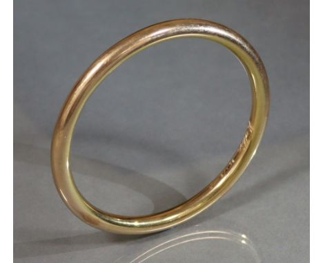 An early 20th century 15ct. gold stiff ‘slave’ bangle, internal diam. 3” (20.5 gm); sold with original receipt from Mappin &a